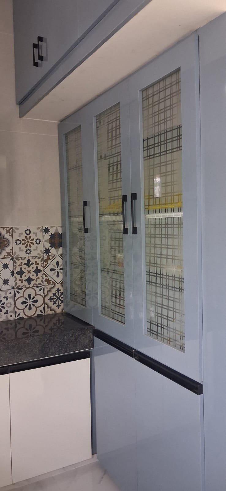 Modular kitchen glass cabinet design by Anjaneya Interiors, Coimbatore