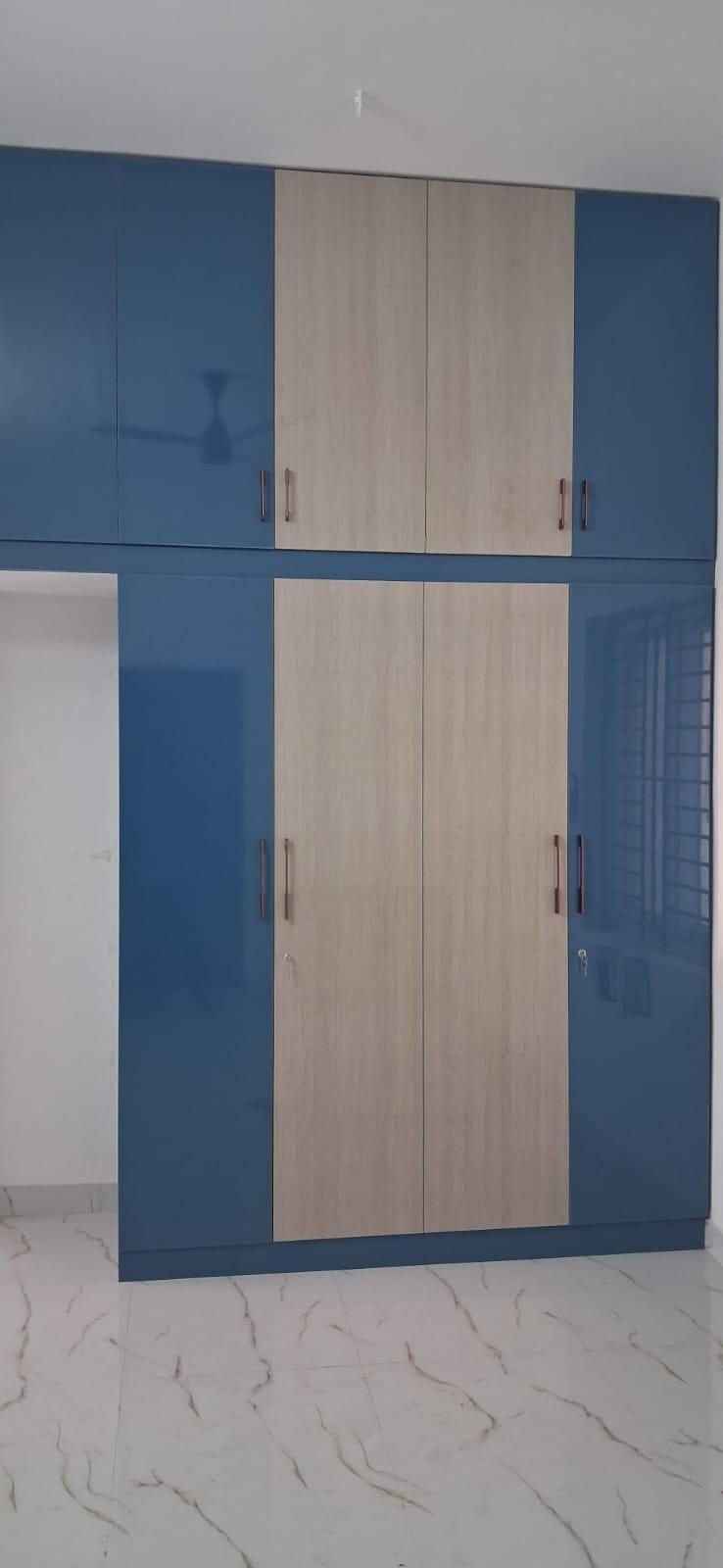 Glossy Blue Wardrobe by Anjaneya Interiors and Furniture, Coimbatore